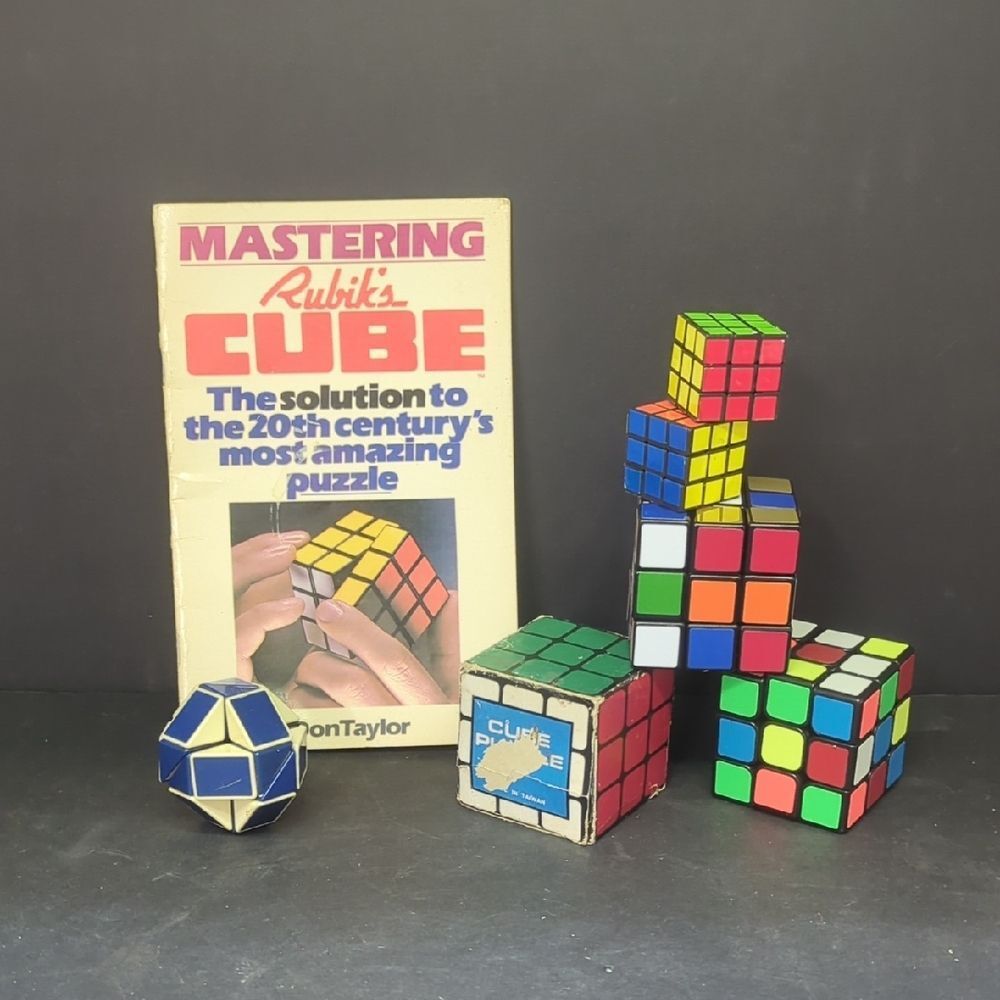 set of vintage Rubik's-style puzzles and Don Taylor book